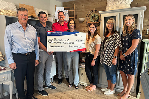 Town & Country staff with owner of The Market on 4th for Small Business Grant check presentation