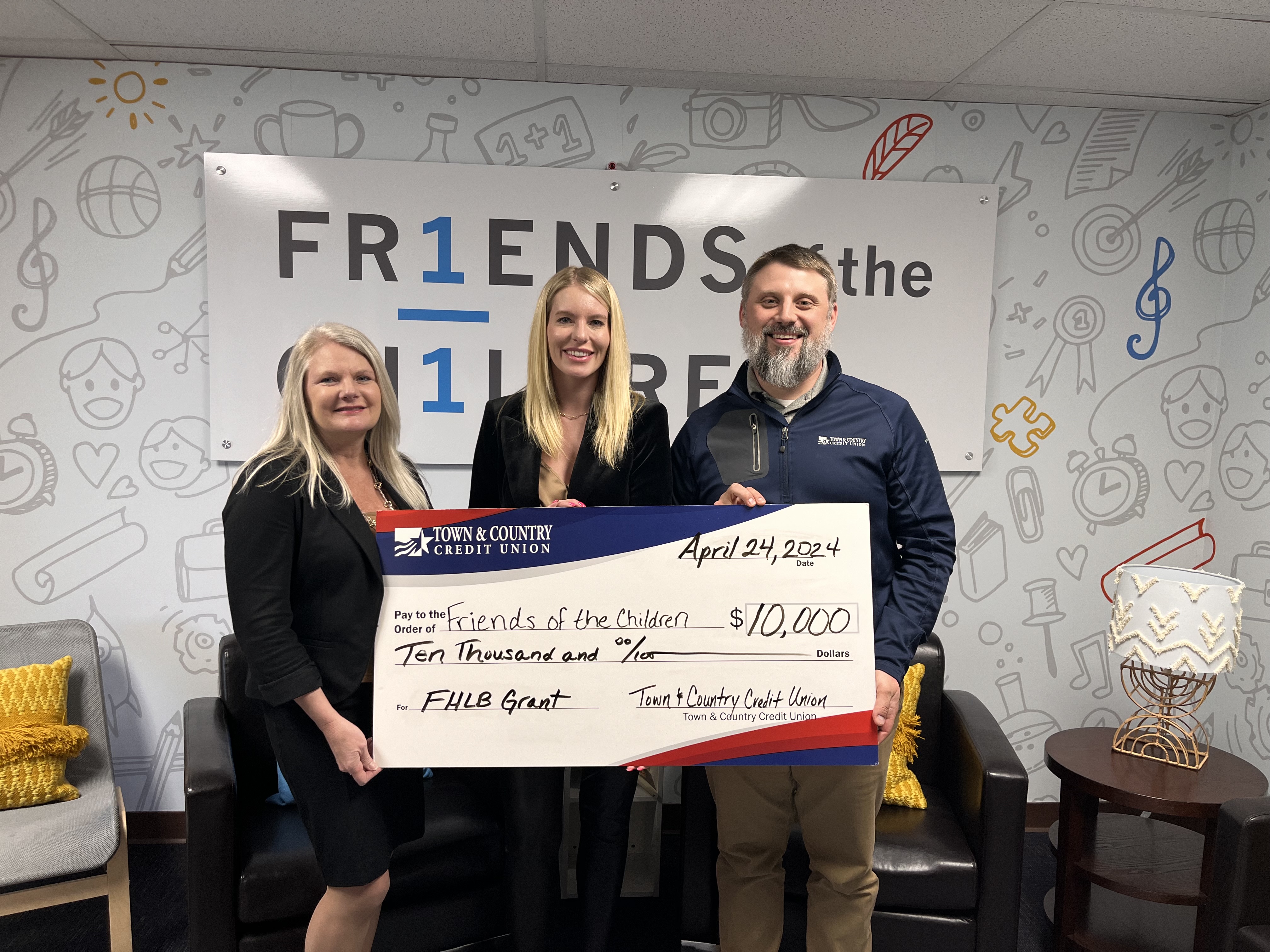 Photo of Town & Country and Friends of the Children Representatives holding a large check for $10,000 presented to the Friends of the Children for a FHLB Grant